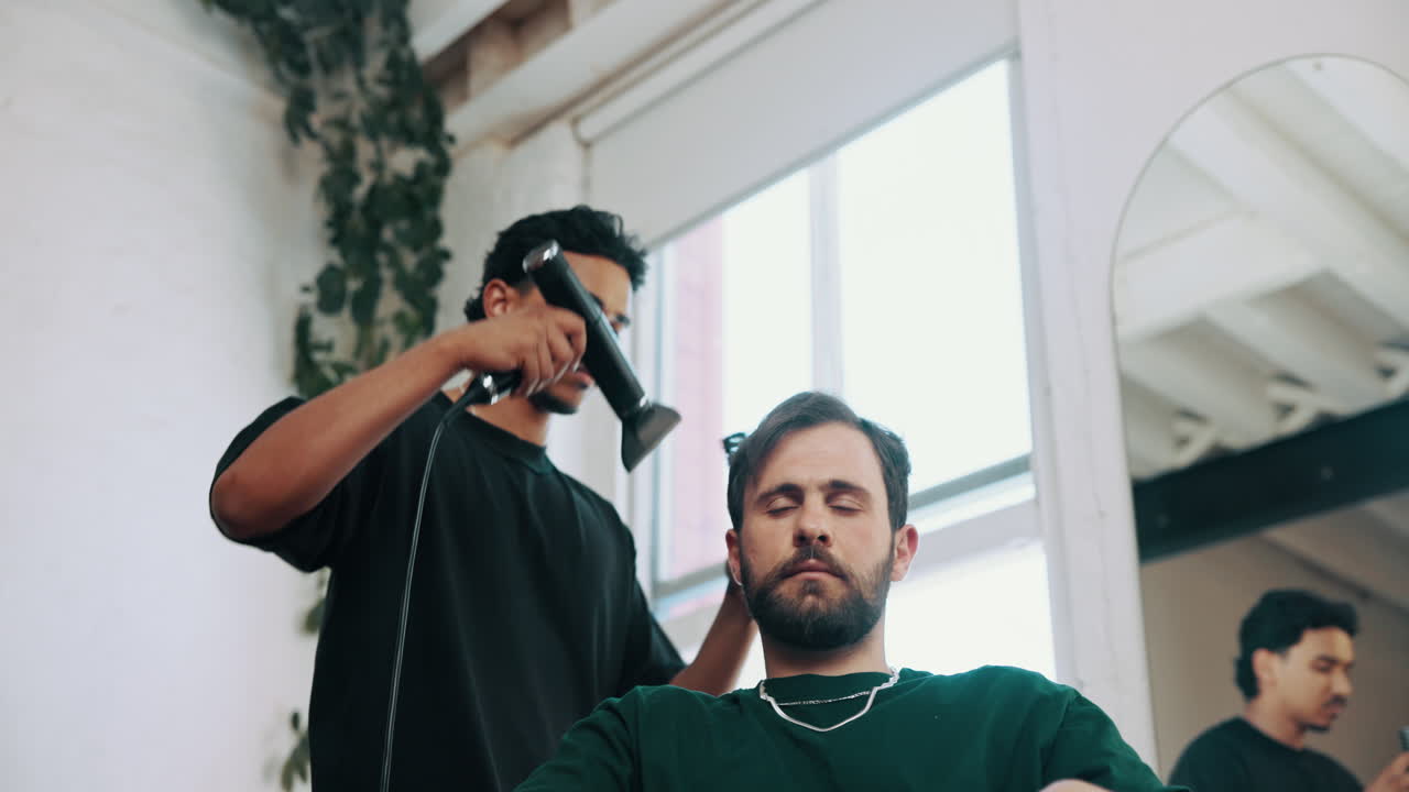 Barber Styling Male Client's Hair with Hairdryer in Modern Salon