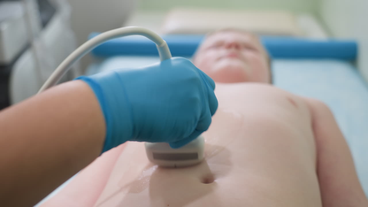 Close up of teenage patient lying calmly on hospital bed as nurse gently examines ribs with ultrasound probe, using blue gloves and steady hand to ensure accurate internal scan for medical diagnosis