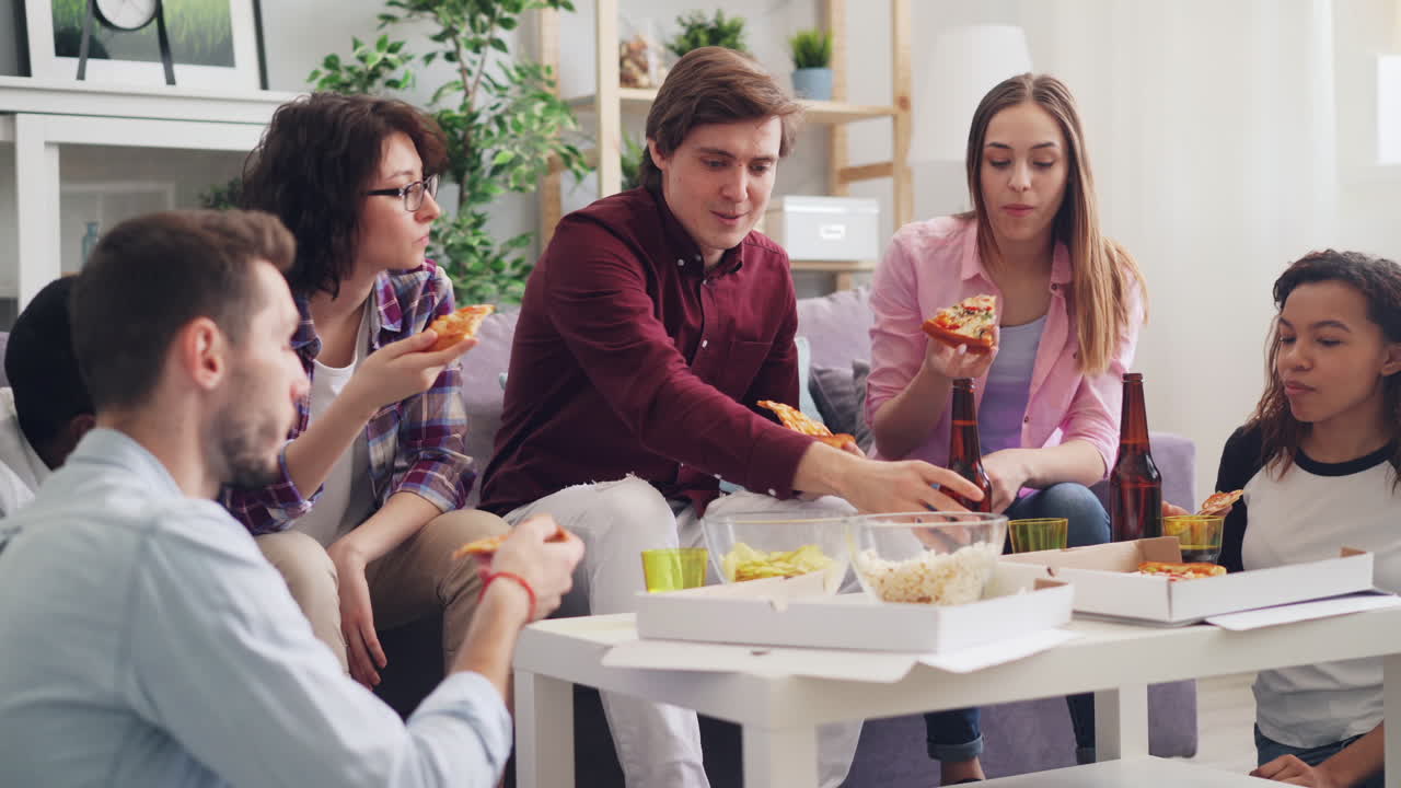 Friends Celebrating with Pizza and Beer