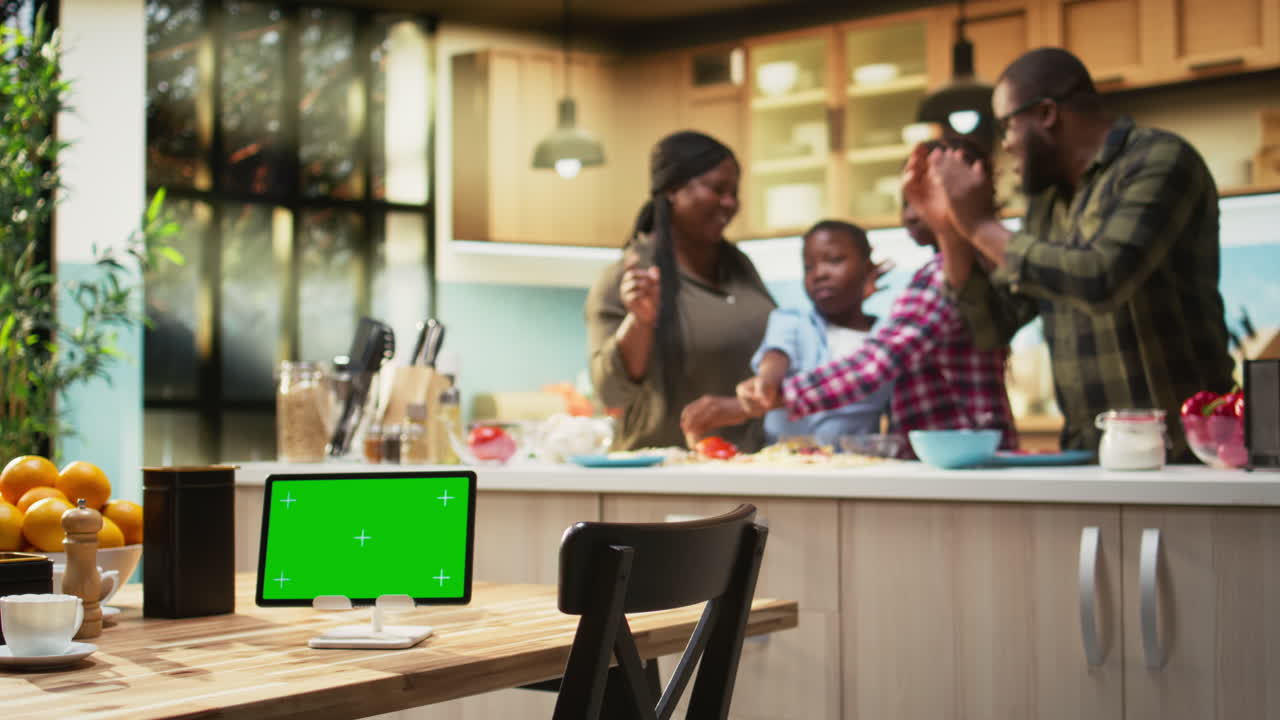 Family Cooking Together in the Kitchen with Tablet