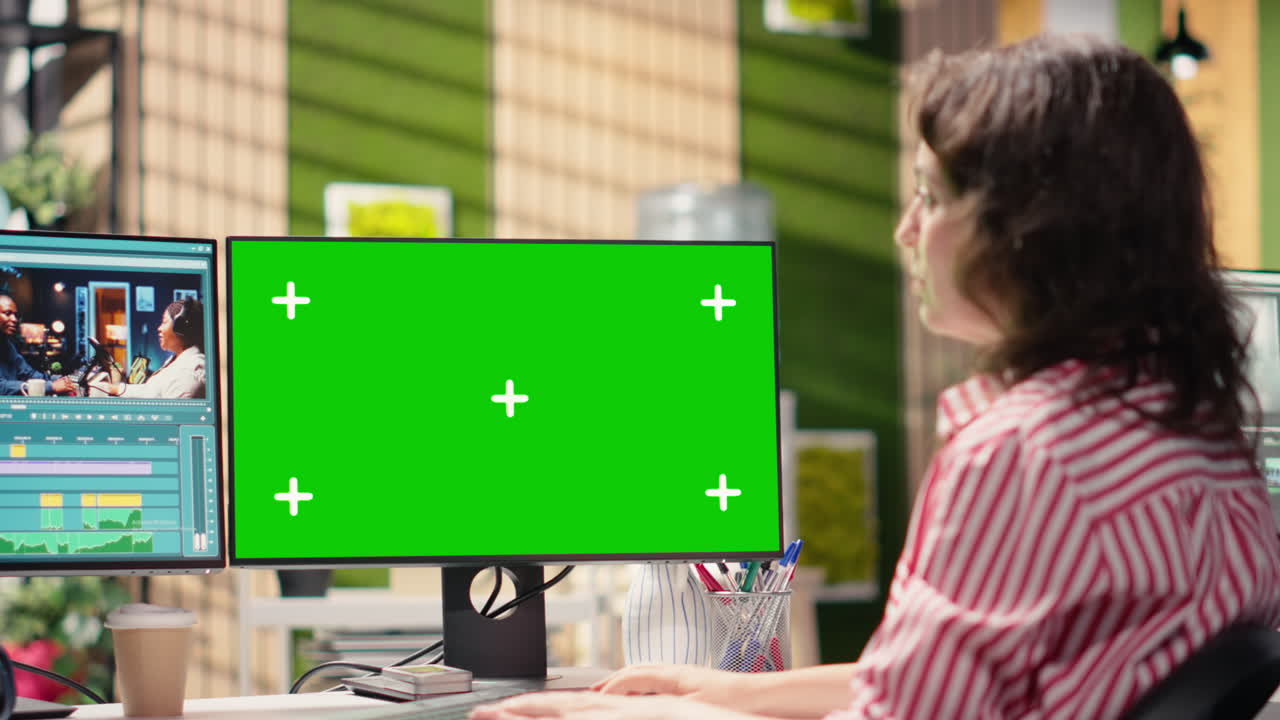 Woman Video Editor Working on Computer with Green Screen Monitor