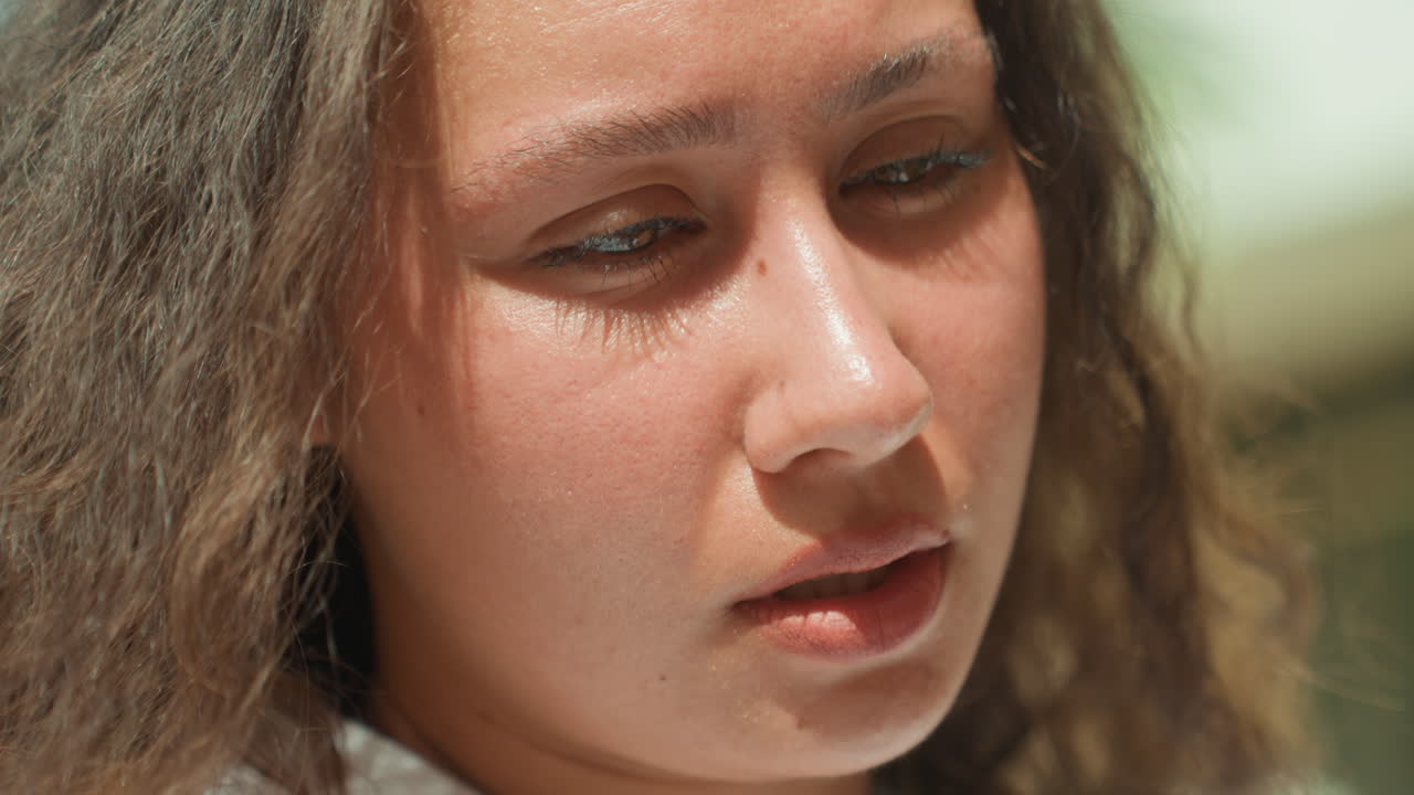 Latina woman closeup on island, sunlit contemplative portrait showing curly hair and dewy skin, subtle freckles, reflective gaze, travel writer vibe, island local nuance, quiet solitude, cinematic