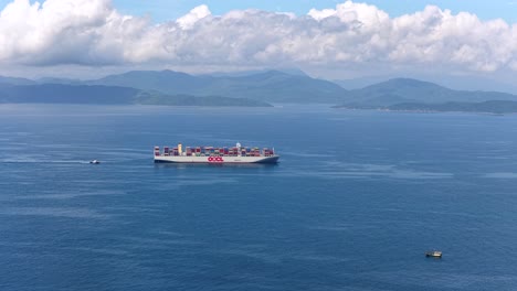 a ten thousand ton giant ship is sailing on the sea, including sea transportation, logistics, and container shipping