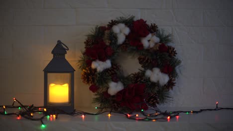 Christmas-wreath-handmade-on-a-wooden-background.-Festive-lights-of-garland.-New-Year's-interior-decoration.