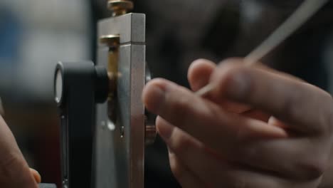 Close-up view of someone working on a metal machine