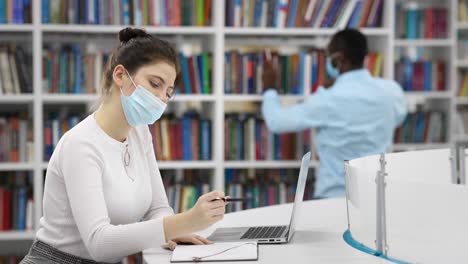students working in a library during covid-19