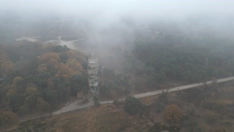 breathtaking aerial footage of a viewpoint in clouds on a heather nature reserve