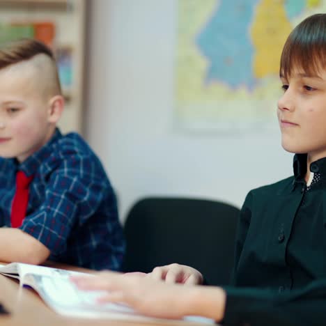 elementary school children study. learning process in the classroom. boys sitting at desk and answering at the lesson. back to school.