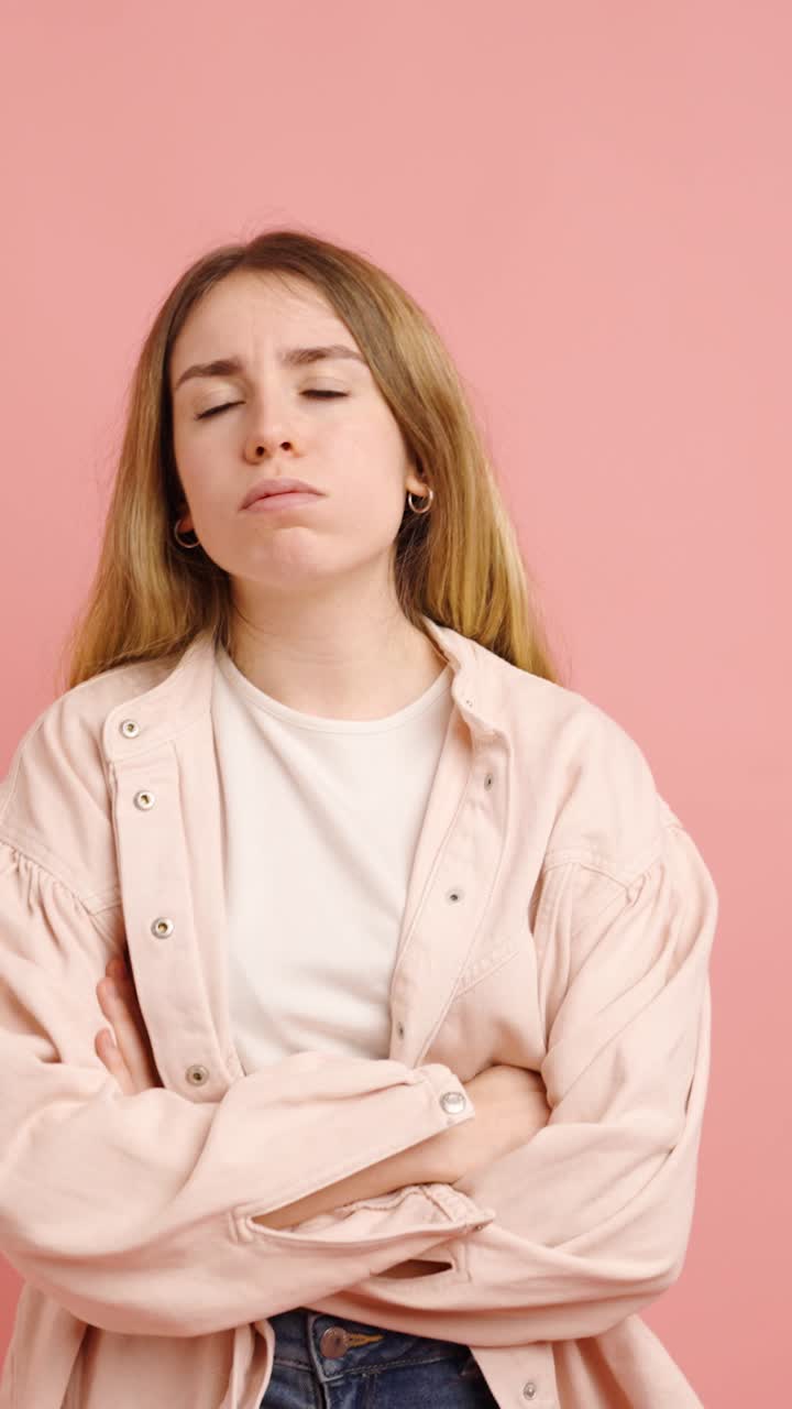 Young woman showing different facial expressions on pink background