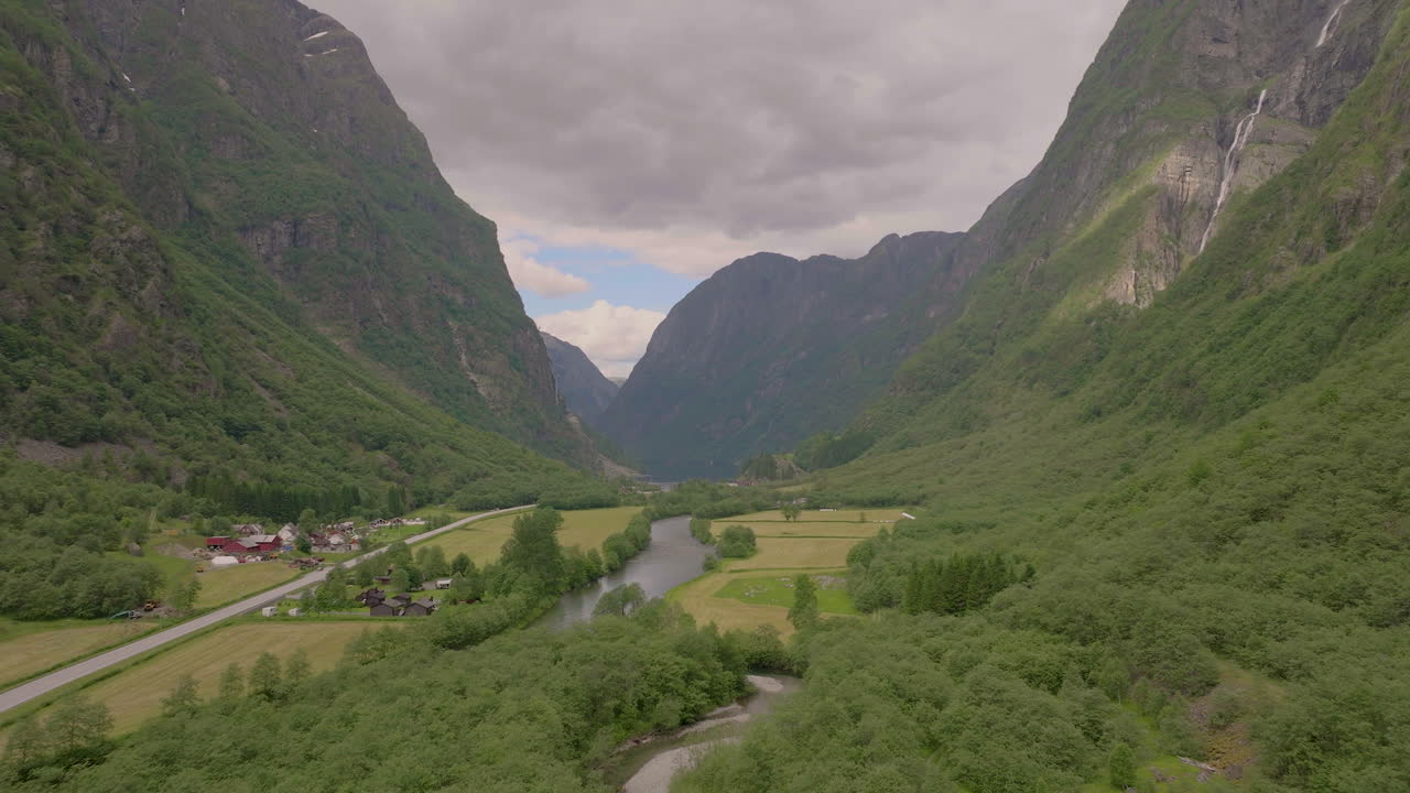 Aerial up scenic Gudvangen Valley - Kjelfossen cascading down steep mountainside