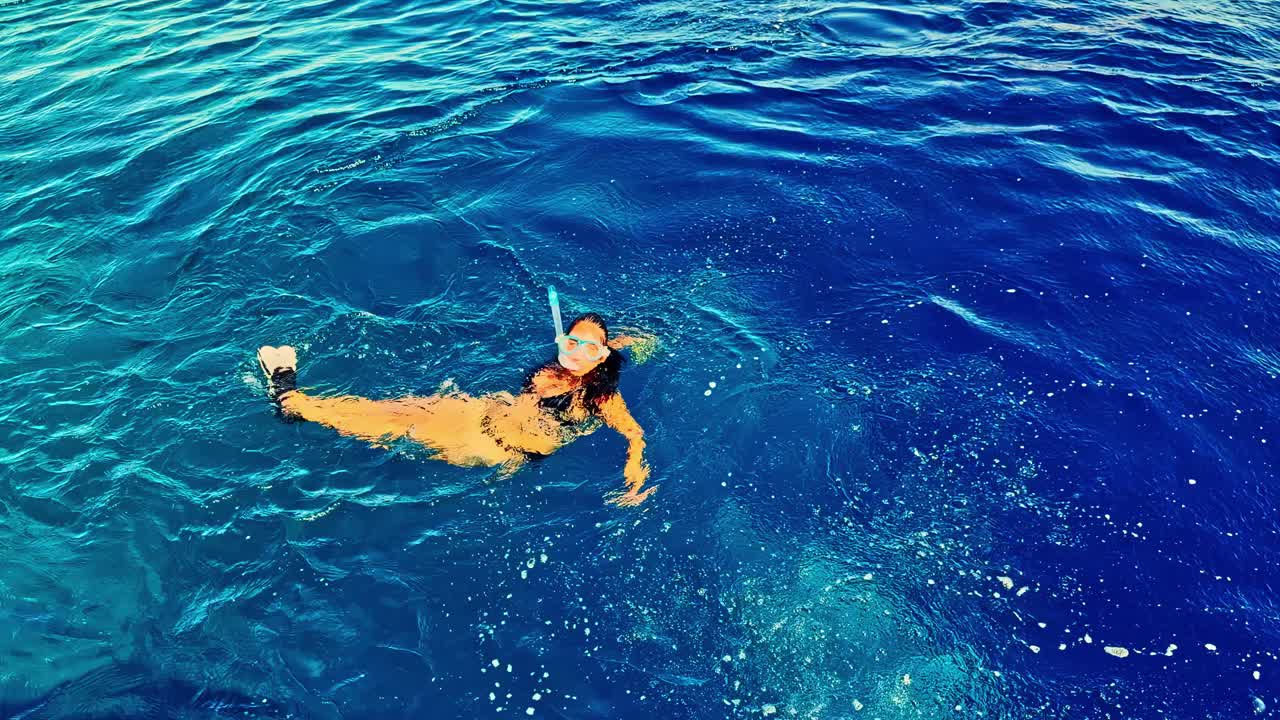 Beautiful woman snorkeling in the Red Sea day trip excursion in Egypt coral spotting