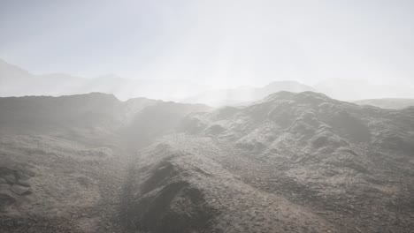 sun rays over mountains in a valley