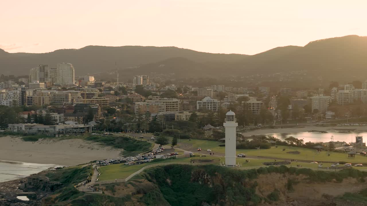 뉴 사우스 웨일즈의 울롱롱 (wollongong) 의 공중 풍경, 해가 뜨는 아름다운 해안 도시를 포착하고, 풍경 위에 부드러운 아침 빛이 있습니다.
