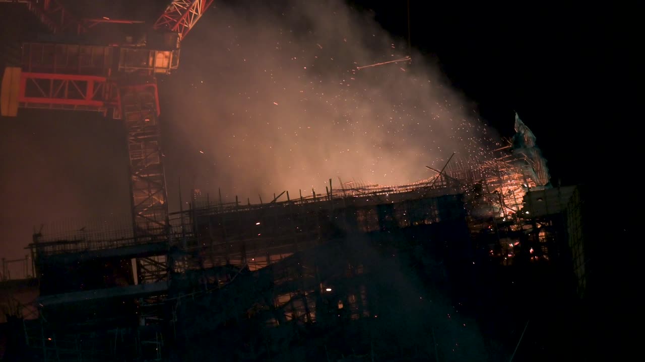 Close up view of a fire incident affecting an skyscraper office building rooftop in Hong Kong