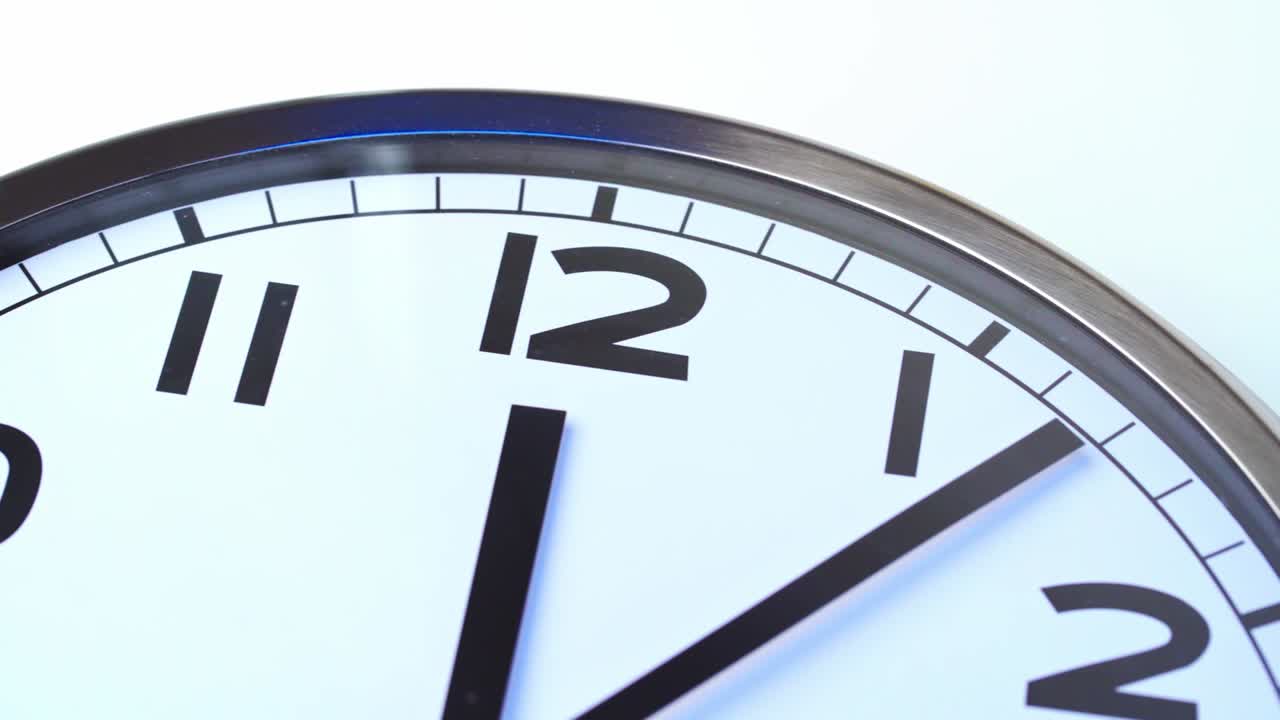 Close up video of clock face on wall