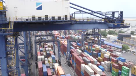 Overlooking-Ship-Docked-At-Terminal-With-Containers-Beside-Gantry-Cranes-At-Karachi-Port-Trust-Terminal