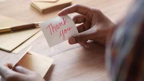 handwritten thank you note on wooden table