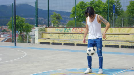 handsome man practicing soccer tricks