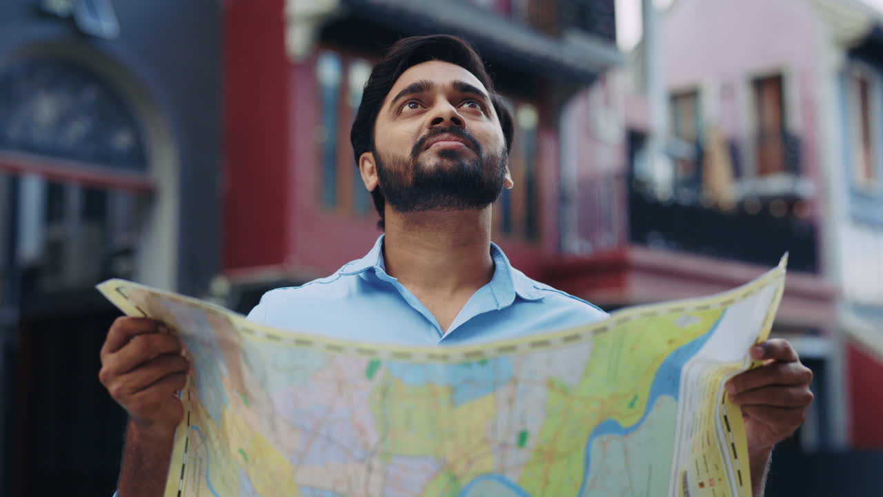 Man holding a map in a city