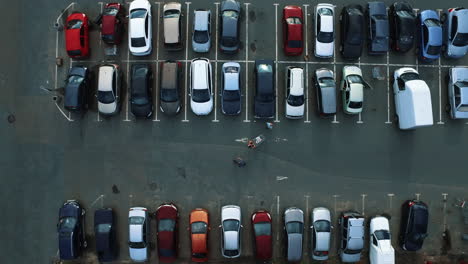 drone footage people moving at parking. copter flying above parking at city