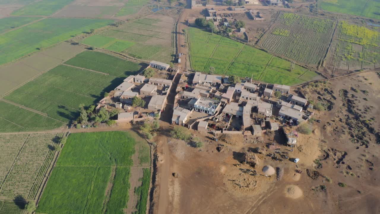 Tiny village and agriculture fields near Sukkur Sindh ascending aerial shot