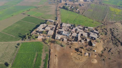 tiny village and agriculture fields near sukkur sindh ascending aerial shot