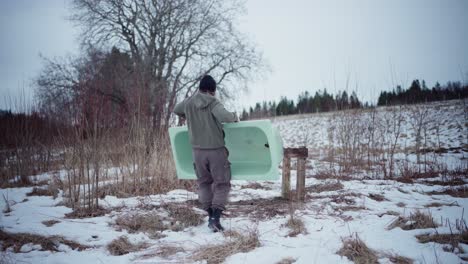 a man is transporting a tub and attaching it securely to the framework support - static shot