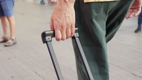 person walking with luggage on a city street