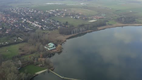 Drone-aerial-of-the-typical-german-village-Seeburg-located-at-the-Seeburger-See-on-a-beautiful-Sunday-morning