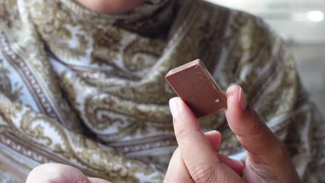 Person holding a piece of chocolate