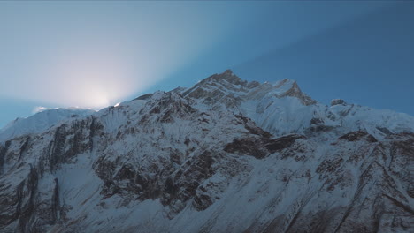 early sunrise from annapurna mountain range, nepal, drone reveals peak shining, blue sky, snow, and amazing time-lapse shot, touristic mountaineering adventure 4k