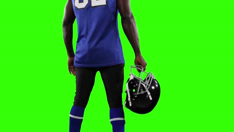 jugador de fútbol americano en el fondo de la pantalla verde.