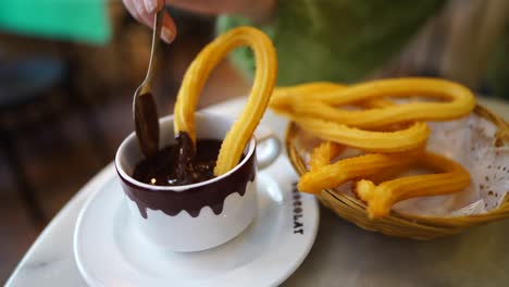 hot chocolate spooned and poured over fresh churros