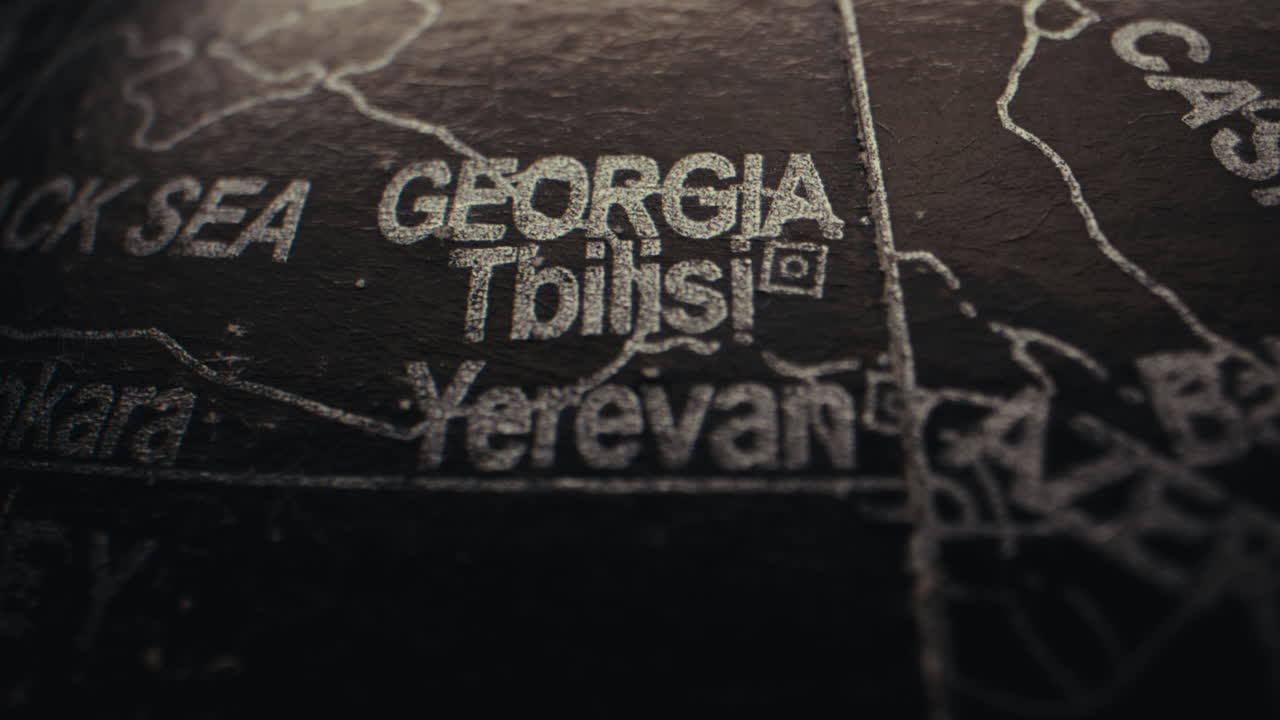 Close-up of a world globe highlighting Georgia and Tbilisi