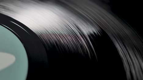 close up, macro shot of old vinyl disc spinning on a record player