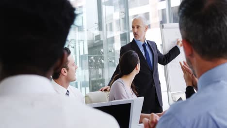 Business-people-applauding-during-a-meeting