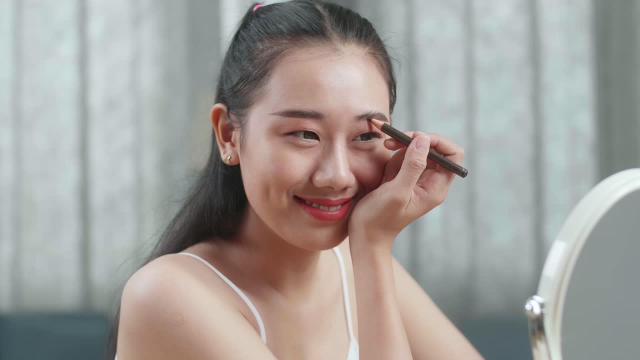 Woman Applying Eyebrow Makeup
