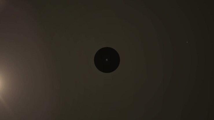 Animation of network of digital icons over light spot against brown background