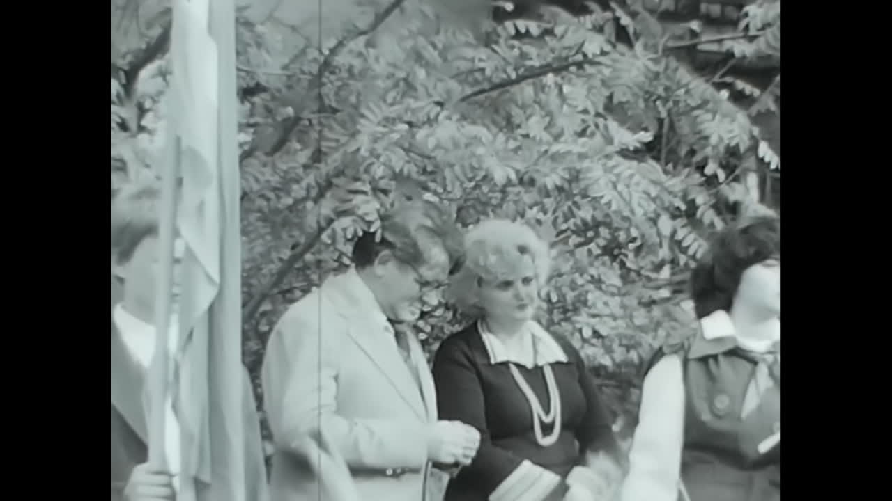 Group of Children Standing in Front of Crowd - Soviet Union Archive Video. CIRCA USSR 1970: A group of children standing together in front of a crowd in a historic video from the Soviet Union.