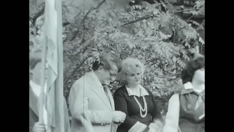group of children standing in front of crowd - soviet union archive video. circa ussr 1970: a group of children standing together in front of a crowd in a historic video from the soviet union.