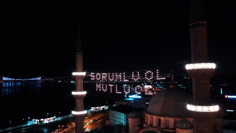 aerial night view of new mosque. there says " be responsible, be happy"