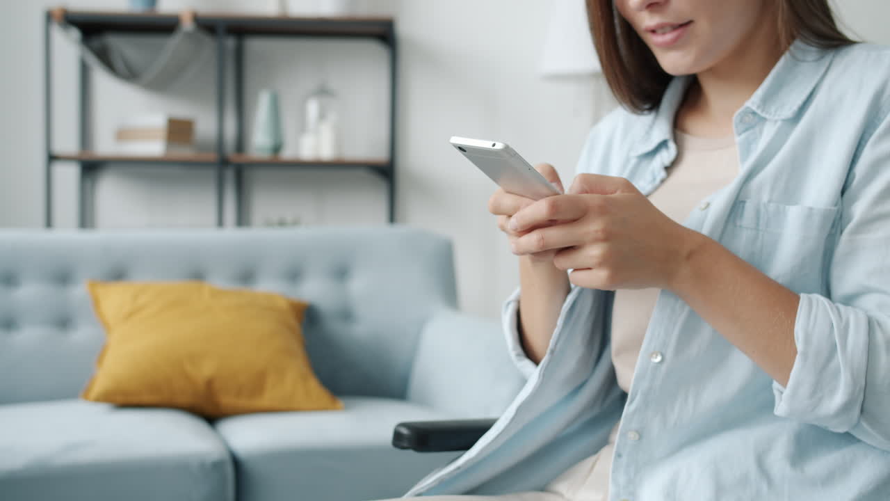 Woman using smartphone in a living room