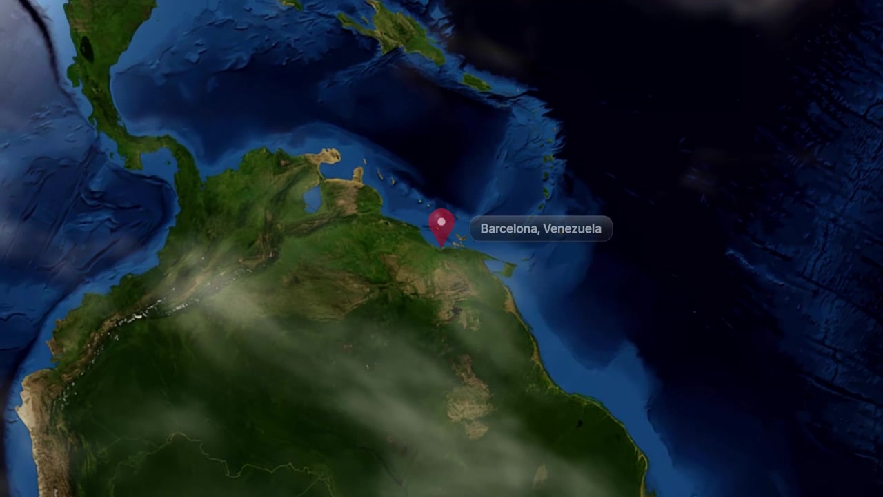 Satellite animation zooms from outer space directly down to Barcelona, Venezuela with pin marker. Includes NASA public domain imagery.