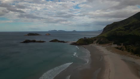 beautiful whangarei heads ocean beach in new zealand on a cloudy day -aerial