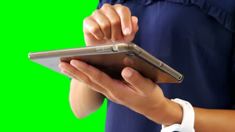 Woman-using-digital-tablet-against-green-screen-4k