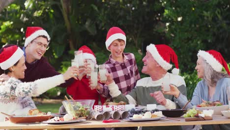 happy caucasian family having christmas dinner in garden