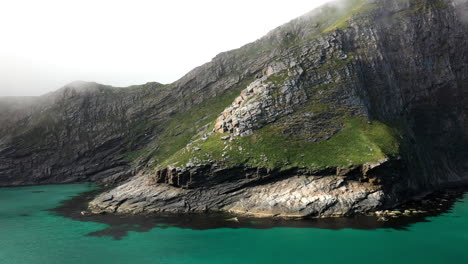 Drone-footage-of-a-rocky-coastline-in-Vaeroy,-Lofoten-Islands-in-Norway
