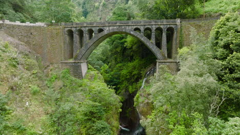 old arch bridge over ravine in madeira interior, a ponte velha