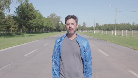 Front-view-man-in-casual-clothes-walking-on-the-street-alone