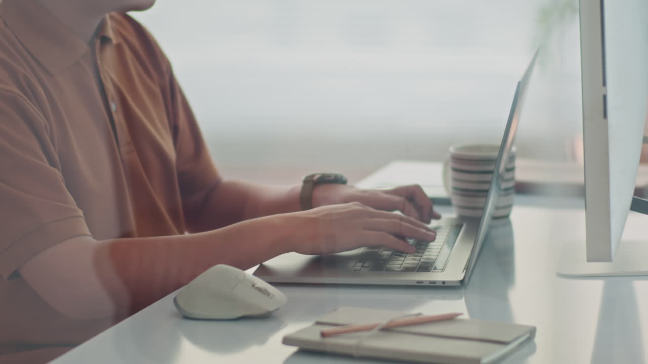Unrecognizable Tester Writing Script on Laptop